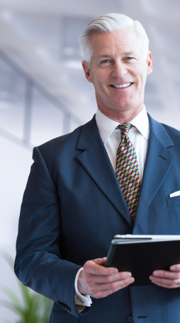 Smiling business owner holding a tablet