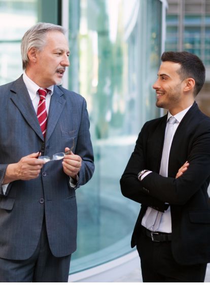Two business owners talking outside an office