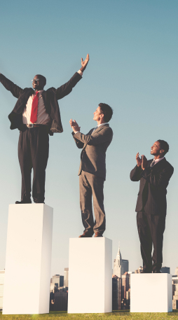 Business people standing on winners’ podiums